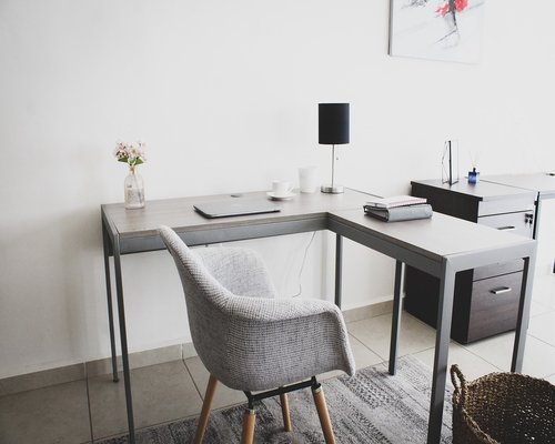 glass of water and notebook on a clean wooden office desk